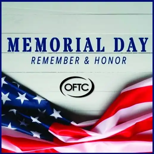 An American flag is draped in the lower corner with the text MEMORIAL DAY REMEMBER & HONOR above the OFTC logo on a wooden background.