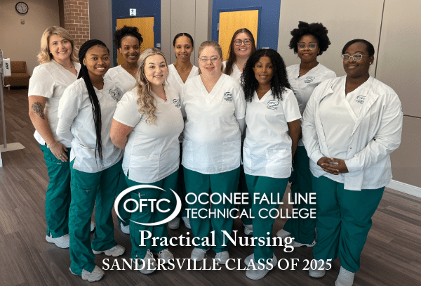 A group of ten nursing students in white tops and green pants stand together, smiling, inside a building. Text reads: Oconee Fall Line Technical College Practical Nursing Sandersville Class of 2025.
