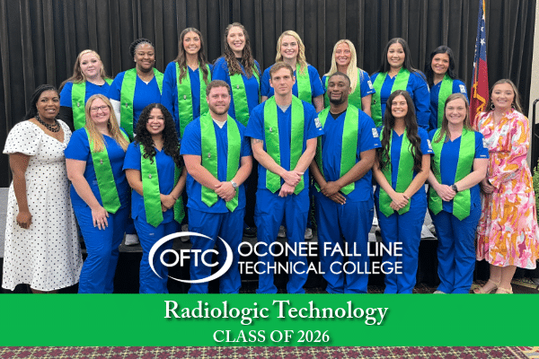 Group of Radiologic Technology students from Oconee Fall Line Tech, Class of 2026, in blue scrubs with green stoles, posing indoors.