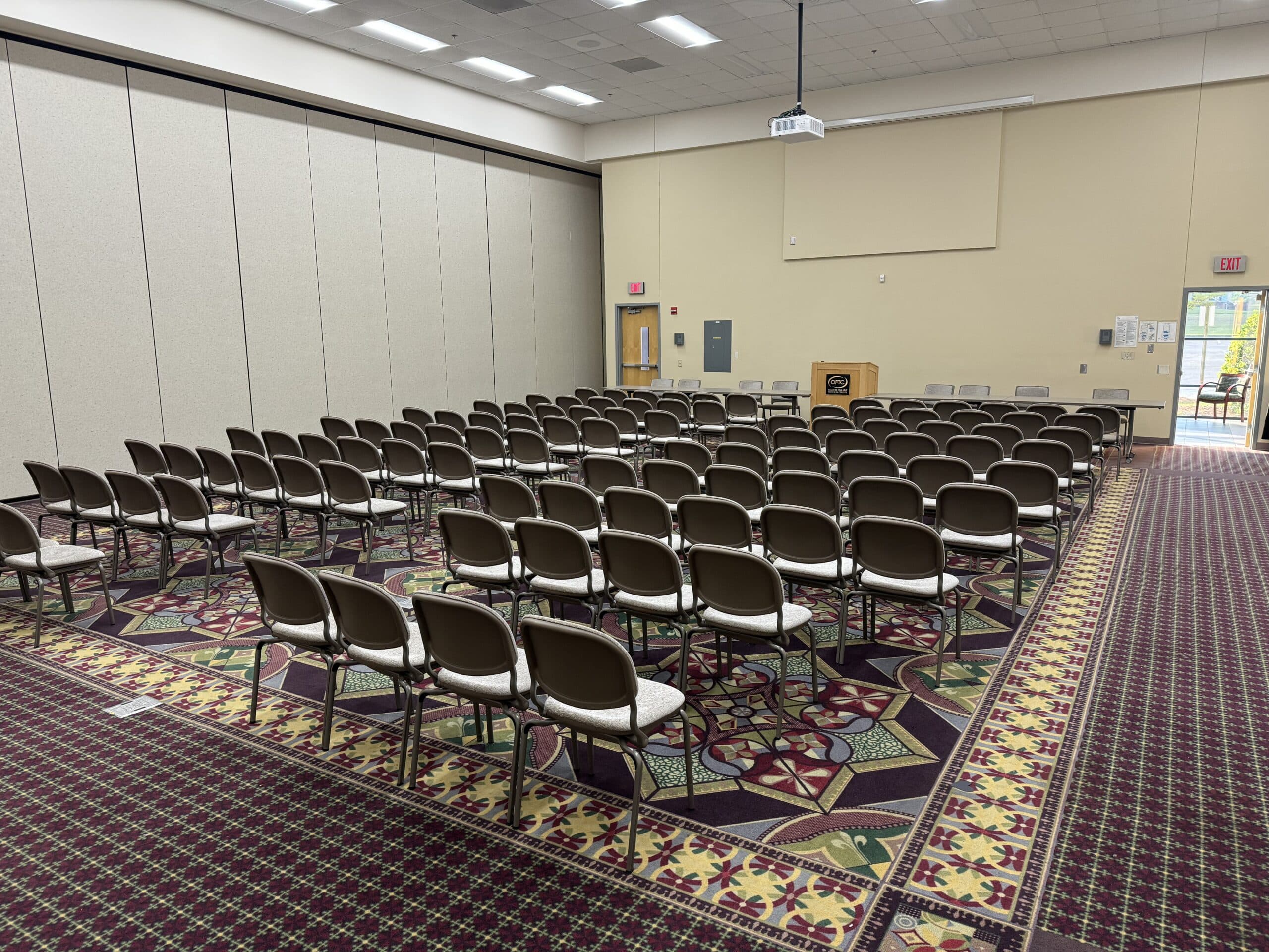 Rows of chairs arranged in a large meeting room with a wooden podium at the front. at Dublin's Porter Center