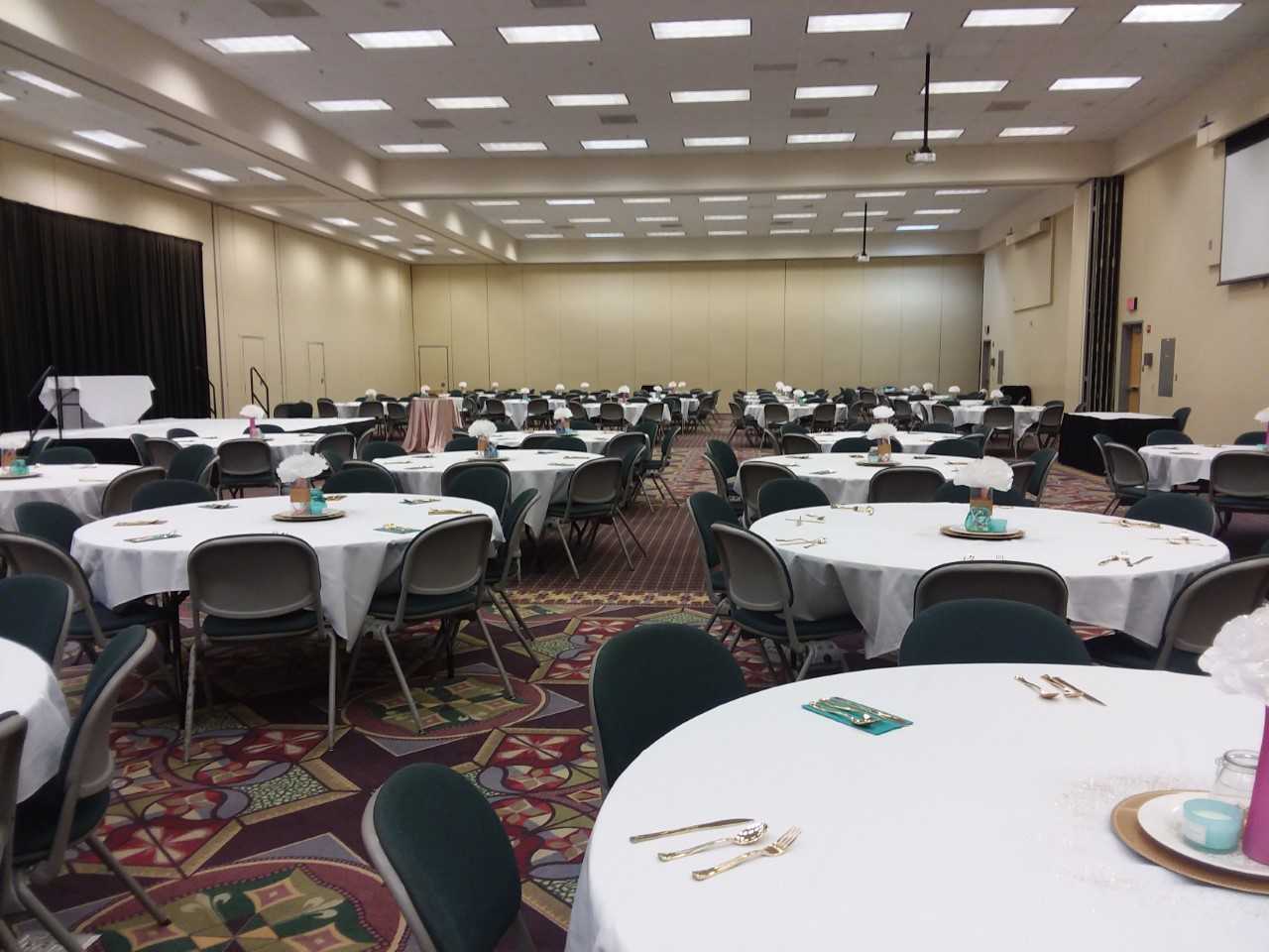 Dublin's Porter Center set up with round tables covered in white tablecloths and arranged with chairs for an event.